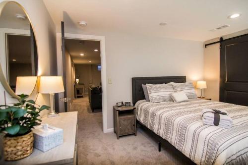 a bedroom with a large bed and a mirror at Four Bedroom house by MSP & MOA! in Richfield