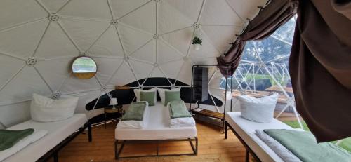 a room with two beds and a large window at Friesland Glamping Camp Schortens in Schortens