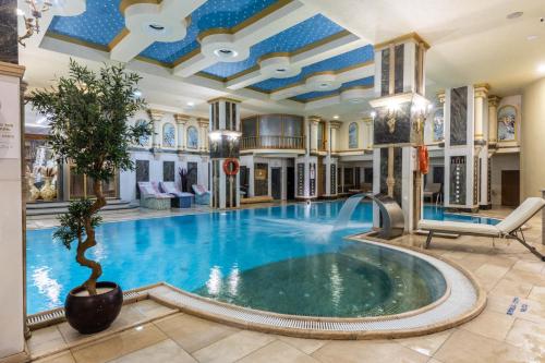 a swimming pool in a house with a ceiling at Wyndham Istanbul Old City in Istanbul