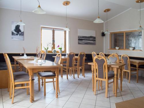 a dining room with wooden tables and chairs at Landgasthof Benjamin in Treffelstein