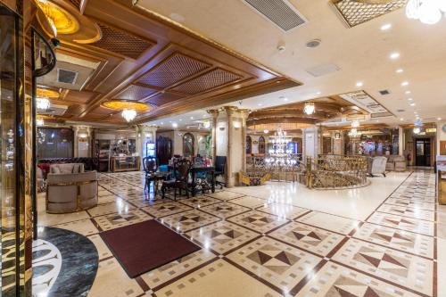 a lobby of a hotel with a table and chairs at Wyndham Istanbul Old City in Istanbul