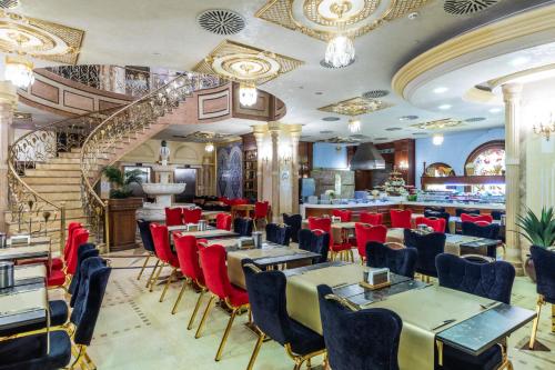 a restaurant with tables and chairs and a staircase at Wyndham Istanbul Old City in Istanbul