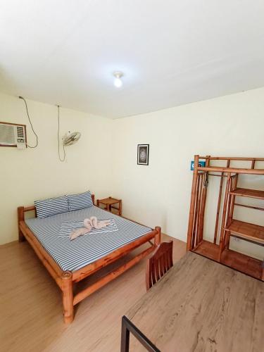 a bedroom with a bed with a towel on it at Ander Divers Garden Resort in Anda