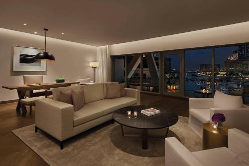 a living room with a couch and a table at The Abu Dhabi EDITION in Abu Dhabi