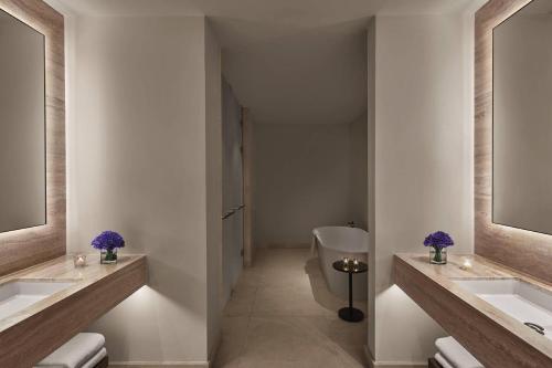 a bathroom with two sinks and a toilet at The Abu Dhabi EDITION in Abu Dhabi
