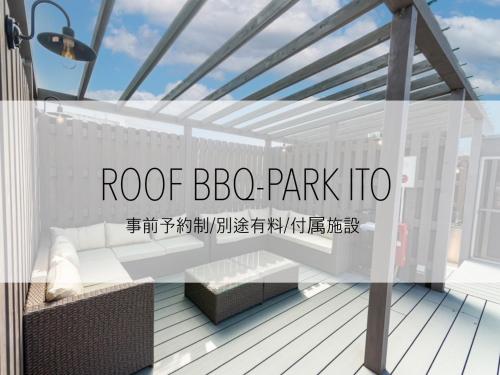 a white pergola on a deck with the words roof bc park info at Smart Stay Ito 302 in Ito