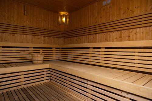 an empty wooden sauna with a bucket in it at Marina Hotel in Kuwait