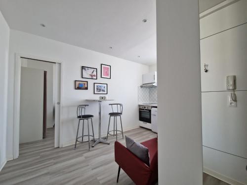 a white apartment with a kitchen and a living room at Le ciel étoilé, Belfort ville in Belfort