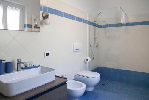 a bathroom with a sink and a toilet and a shower at Moncrivel Rooms & Relax in Benevello