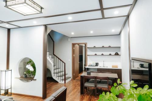 a kitchen and dining room with a dining table and a staircase at Room in Wyndham Thanh Thuy Hot Spring MyHome in La Phu