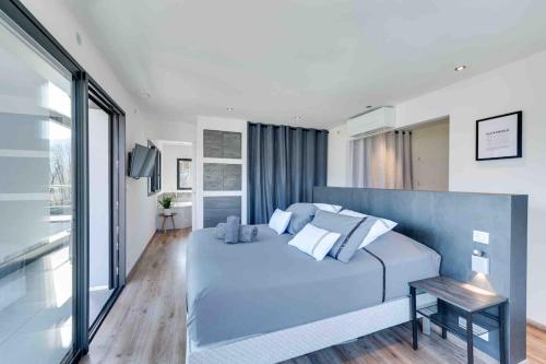 Un dormitorio con una gran cama azul y una ventana en Villa Bamboo en Lathuile