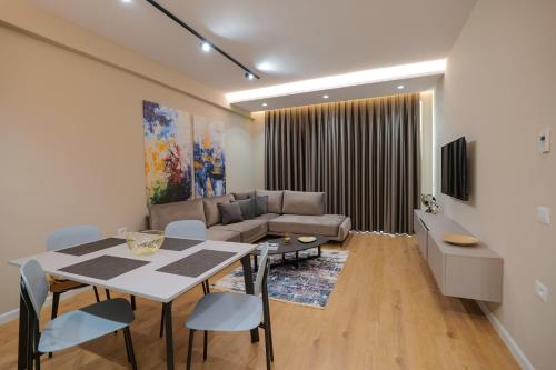 a living room with a table and a couch at DAED Luxury Residence in Sarandë