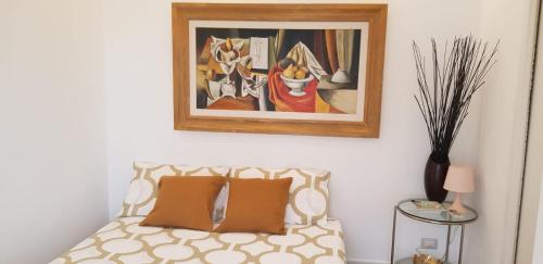 a bedroom with a bed with a painting on the wall at Eolia free parking in Bari