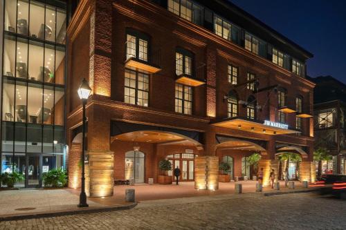 a large brick building with a street light in front of it at JW Marriott Savannah Plant Riverside District in Savannah