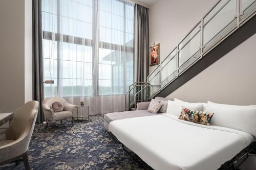 a hotel room with a bed and a staircase at JW Marriott Savannah Plant Riverside District in Savannah
