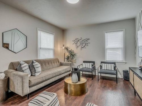 a living room with a couch and two chairs at The Noir in Oklahoma City