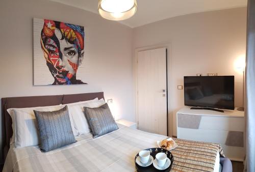 a bedroom with a large bed with a tv on the wall at Luxury Villa Četiri Hrasta Apartment in Pićan