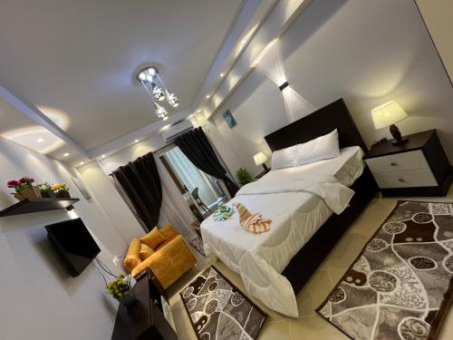 a small bedroom with a bed in a room at Florence khamsin - dream house in Hurghada