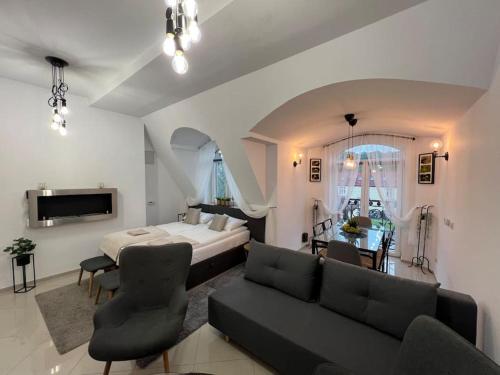 a living room with a bed and a couch at Salt INN Apartments No 1 in Wieliczka
