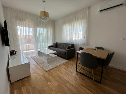 a living room with a couch and a table at Apartman Čapljina in Čapljina