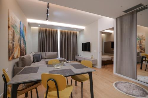 a living room with a table and a couch at DAED Luxury Residence in Sarandë