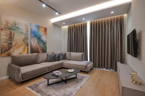 a living room with a couch and a table at DAED Luxury Residence in Sarandë