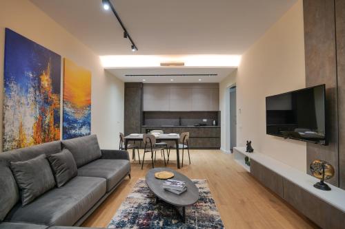 a living room with a couch and a table at DAED Luxury Residence in Sarandë