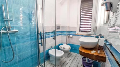 a bathroom with a toilet and a sink and a shower at Cala Dei Romani in Ventotene