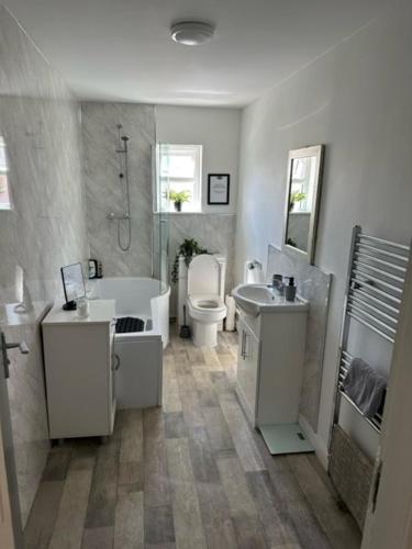 La salle de bains est pourvue de 2 lavabos, d'une baignoire et de toilettes. dans l'établissement The Grosvenor Free house, à Scunthorpe