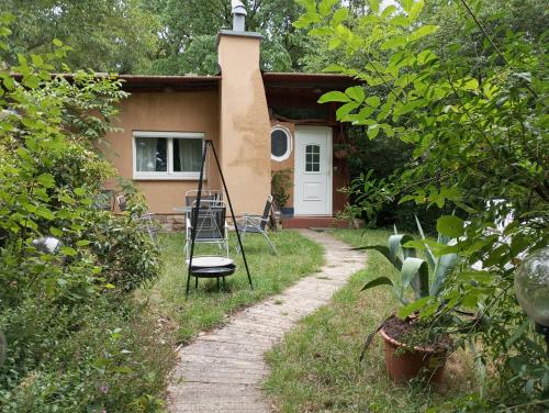 una casa con porche y una silla delante de ella en Retreat Wilderness Lössnitz-Hochland Moritzburg OT Reichenberg, en Moritzburg