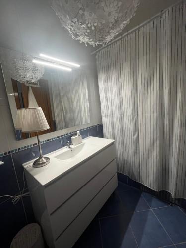 uma casa de banho com um lavatório e um espelho em Cozy Apartment em Santa Luzia