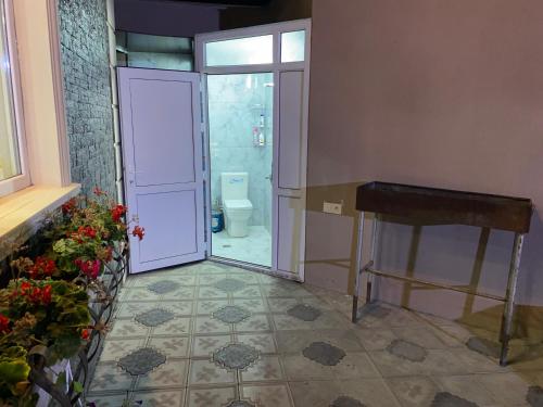 a bathroom with a door leading to a toilet at Elite Novkhany-Corat Villa in Corat