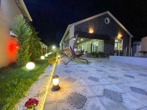 a patio at night with candles and a house at Elite Novkhany-Corat Villa in Corat