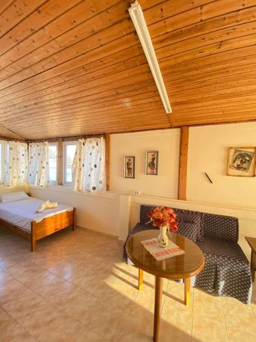 a living room with a couch and a table at Blue Sky Apartment Paralia in Paralia Katerinis