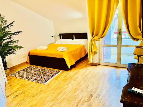 a bedroom with a bed and a large window at Yellow House in Teramo
