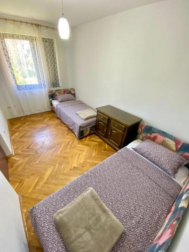 a living room with two beds and a couch at Apartman Akvamarin in Vrnjci