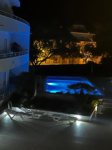 a night view of a swimming pool in a building at Cozy Apartment in Santa Luzia