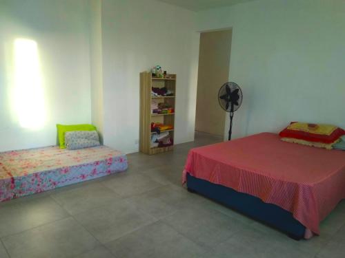 a bedroom with two beds and a fan at Residence Lavande in Rose Hill