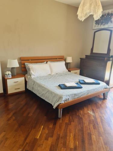 a bedroom with a bed with two towels on it at Mosè House in Formia