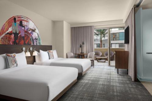 a hotel room with two beds and a desk at W Scottsdale in Scottsdale