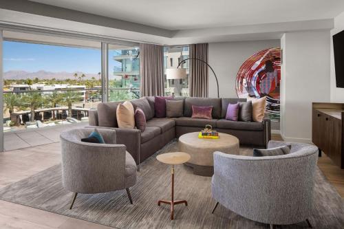 a living room with a couch and chairs and a table at W Scottsdale in Scottsdale