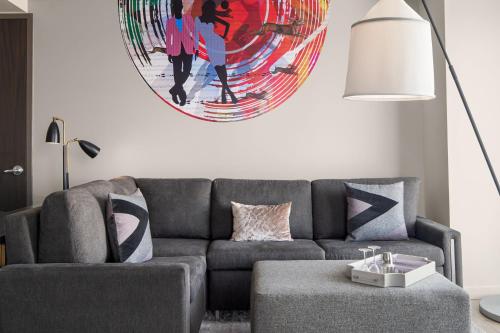 a living room with a couch and a large painting on the wall at W Scottsdale in Scottsdale