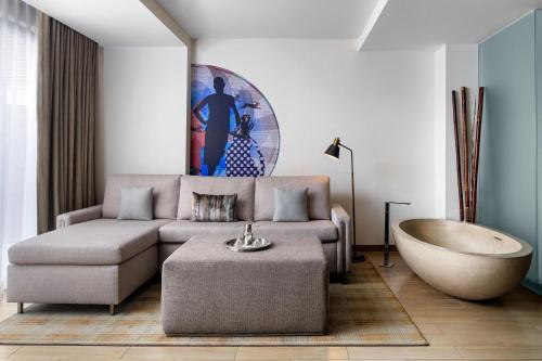 a living room with a couch and a bath tub at W Scottsdale in Scottsdale