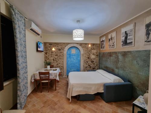 a room with two beds and a table and a tv at Dimora Sogno Suite in Termoli