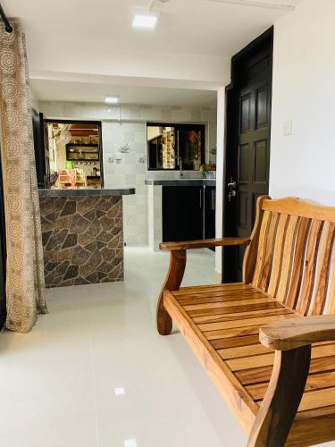a wooden bench in a kitchen with a counter at Oceanic View Apartments in Beau Vallon