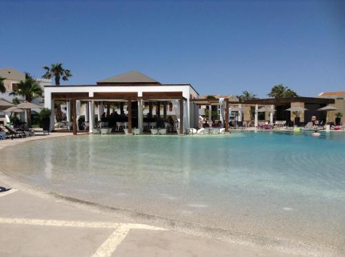 a large pool of water in front of a resort at Pelagos Suites Hotel & Spa in Kos Town