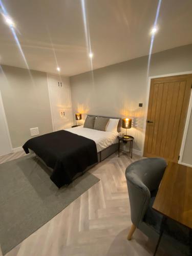 a bedroom with a bed and a couch and a table at Luxury 2 bed 1 bath in Central London by Graceful Apartments in London