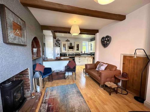 a living room with a couch and a fireplace at A character property close to Lichfield Cathedral in Lichfield