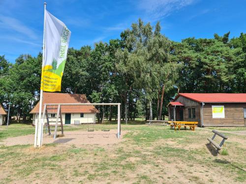 a flag in front of a park with a building at Jugendtours-Feriendorf Ummanz in Ummanz