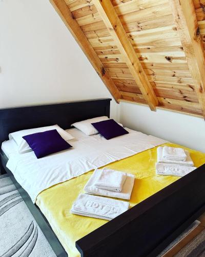 a bedroom with two beds with blue pillows at Forest Panorama Cabin Brezna in Pluzine